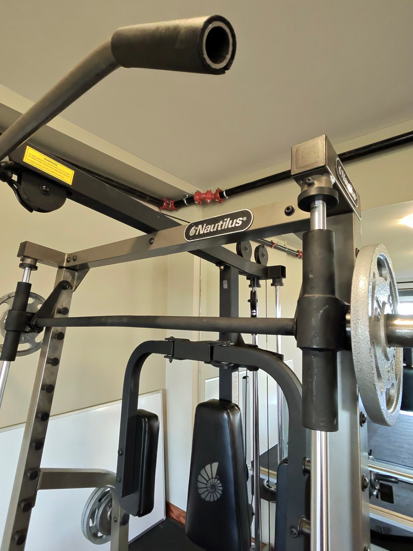 Multi-station weight machine in the on-site fitness room at Halo Ridge Recovery